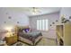 Cozy bedroom with light purple walls, a ceiling fan, and window with wooden blinds at 6030 W Topeka Dr, Glendale, AZ 85308