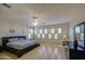 Spacious bedroom with hardwood floors, plantation shutters, wallpaper and a comfortable king-sized bed at 6030 W Topeka Dr, Glendale, AZ 85308