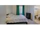 Comfortable bedroom with a floral patterned bedspread, dark wood dresser, and an ensuite bathroom at 6030 W Topeka Dr, Glendale, AZ 85308