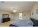 Bright bedroom featuring hardwood floors, wallpaper, king-sized bed and ensuite bathroom at 6030 W Topeka Dr, Glendale, AZ 85308