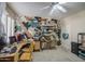 Comfortable bedroom space with neutral beige walls, light wood desk and seating, and unique camouflage wall decor at 6030 W Topeka Dr, Glendale, AZ 85308