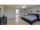 Well-lit bedroom with hardwood floors, wallpaper, king-sized bed and ensuite bathroom at 6030 W Topeka Dr, Glendale, AZ 85308