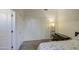 Bright bedroom featuring neutral carpeting, and a minimalist design with modern lighting fixtures at 6030 W Topeka Dr, Glendale, AZ 85308