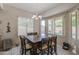 Bright dining room features large windows and a wooden table with seating for six at 6030 W Topeka Dr, Glendale, AZ 85308
