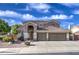 Charming two-story home with a spacious three-car garage and a well-maintained front yard at 6030 W Topeka Dr, Glendale, AZ 85308
