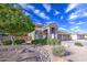 The home has a well-manicured lawn and beautiful landscaping, adding to its curb appeal at 6030 W Topeka Dr, Glendale, AZ 85308