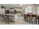 Open-concept kitchen with stainless steel appliances, granite countertops, and seamless flow to dining area at 6030 W Topeka Dr, Glendale, AZ 85308