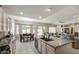 Open-concept kitchen featuring granite counters, breakfast bar, and seamless flow to dining area at 6030 W Topeka Dr, Glendale, AZ 85308