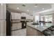Kitchen with modern appliances, light countertops and cabinets, and a center island with seating at 6030 W Topeka Dr, Glendale, AZ 85308