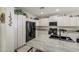 Stylish kitchen with stainless appliances, granite countertops, and ample cabinet space at 6030 W Topeka Dr, Glendale, AZ 85308