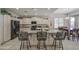 Spacious kitchen with modern black appliances, light countertops, and a tile floor at 6030 W Topeka Dr, Glendale, AZ 85308