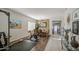 Bright living area with dining table, exercise equipment, and tile flooring at 6030 W Topeka Dr, Glendale, AZ 85308