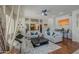 Spacious living room with neutral décor, ceiling fan, and view to the backyard at 6030 W Topeka Dr, Glendale, AZ 85308