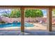 Beautiful pool featuring a rock waterfall design with lots of plants and a private patio with seating at 6030 W Topeka Dr, Glendale, AZ 85308