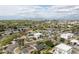 Aerial view of a neighborhood featuring a canal, mature trees, and city views at 6522 E 2Nd St, Scottsdale, AZ 85251