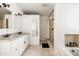Bathroom with double vanity, stone tile shower, and a soaking tub at 6522 E 2Nd St, Scottsdale, AZ 85251