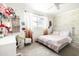 Bedroom featuring soft pink bedding, a work station, and a floral wallpaper accent wall at 6522 E 2Nd St, Scottsdale, AZ 85251