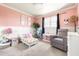 Bright bedroom with pink and white walls, a twin bed, and a comfy chair at 6522 E 2Nd St, Scottsdale, AZ 85251