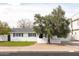 Charming white home featuring manicured landscaping and a mature tree, exuding curb appeal at 6522 E 2Nd St, Scottsdale, AZ 85251