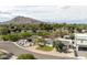 Aerial view of houses with desert landscaping and a mountain backdrop on a bright day at 6522 E 2Nd St, Scottsdale, AZ 85251