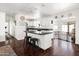 Open-concept kitchen featuring an island with seating, white cabinets, and modern appliances at 6522 E 2Nd St, Scottsdale, AZ 85251