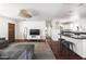 Spacious living room with hardwood floors, white walls, and a modern kitchen with breakfast bar at 6522 E 2Nd St, Scottsdale, AZ 85251