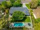 Aerial view of the backyard featuring a pristine pool, verdant lawn, and patio of a beautifully landscaped home at 6837 E Lafayette Blvd, Scottsdale, AZ 85251