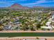Scenic aerial view of home location with marker pin close to a canal, green areas and with mountain views in the distance at 6837 E Lafayette Blvd, Scottsdale, AZ 85251