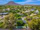 Expansive aerial view showcasing the house nestled in a lush neighborhood with mountain views and a refreshing pool at 6837 E Lafayette Blvd, Scottsdale, AZ 85251