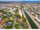 Aerial view of a house located alongside a canal, blending residential charm with natural surroundings and urban accessibility at 6837 E Lafayette Blvd, Scottsdale, AZ 85251