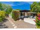 Charming backyard with an outdoor seating area, lush greenery, and privacy landscaping at 6837 E Lafayette Blvd, Scottsdale, AZ 85251