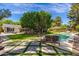 Gorgeous backyard with a sparkling pool, lush greenery, comfortable lounge chairs and mature trees at 6837 E Lafayette Blvd, Scottsdale, AZ 85251