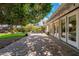 Outdoor brick patio with views of the lawn and lush mature shade trees at 6837 E Lafayette Blvd, Scottsdale, AZ 85251