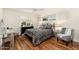 Cozy bedroom featuring hardwood floors, neutral colors, and backyard views at 6837 E Lafayette Blvd, Scottsdale, AZ 85251