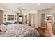 Comfortable bedroom with hardwood floors, backyard access, and neutral paint at 6837 E Lafayette Blvd, Scottsdale, AZ 85251