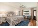 Bright bedroom featuring hardwood floors, a tufted headboard, and sitting area near the window at 6837 E Lafayette Blvd, Scottsdale, AZ 85251