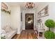 Inviting entryway with hardwood floors, stylish decor, and a charming wooden door at 6837 E Lafayette Blvd, Scottsdale, AZ 85251