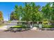 Beautifully landscaped home featuring a charming white brick exterior and paved driveway at 6837 E Lafayette Blvd, Scottsdale, AZ 85251
