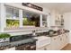 Close-up view of the kitchen sink with a bright window overlooking the lush outdoors at 6837 E Lafayette Blvd, Scottsdale, AZ 85251