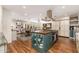 Open kitchen with an island, a gas range, and views of living and dining areas at 6837 E Lafayette Blvd, Scottsdale, AZ 85251