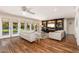Bright living room with hardwood floors, neutral furniture, and French doors to the backyard at 6837 E Lafayette Blvd, Scottsdale, AZ 85251