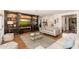 Comfortable living room featuring hardwood floors, a stylish entertainment center, and ample seating at 6837 E Lafayette Blvd, Scottsdale, AZ 85251