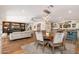 Spacious living area with hardwood floors, an open kitchen, and a cozy seating area with a fireplace at 6837 E Lafayette Blvd, Scottsdale, AZ 85251