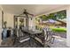 Relaxing covered patio with dining table, ceiling fan and views of backyard at 6837 E Lafayette Blvd, Scottsdale, AZ 85251