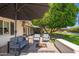 Relaxing outdoor space featuring a fire pit, patio furniture, and view of the lush backyard and pool at 6837 E Lafayette Blvd, Scottsdale, AZ 85251