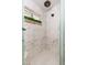 Shower featuring white marble tile and a rain shower head at 6837 E Lafayette Blvd, Scottsdale, AZ 85251