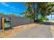 A secure walled property with a stylish gate, providing privacy and hinting at the beautiful interior at 6837 E Lafayette Blvd, Scottsdale, AZ 85251