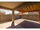 Covered back patio showcasing wooden beam pergola and brick pavers at 7343 W Hughes Dr, Phoenix, AZ 85043