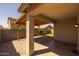 Charming covered back patio with wooden beams, brick pavers, and a glimpse of the yard at 7343 W Hughes Dr, Phoenix, AZ 85043