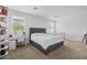 Bright primary bedroom featuring a cozy bed, and a dedicated desk area at 7343 W Hughes Dr, Phoenix, AZ 85043